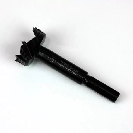 Forstner drill bit for woodworking, black with sharp teeth, isolated on white background