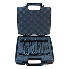 Black tool case with compartments holding black Famag forstner bits on a white background