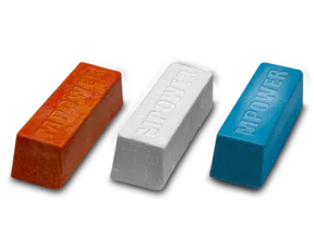 Three wood finishing wax bars in orange, white, and blue on a black background.