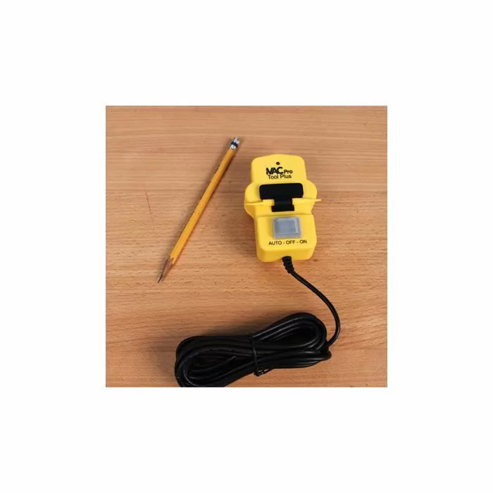 Yellow power tool switch controller with cord and pencil on wooden surface