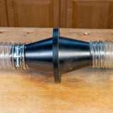 Dust collection hose connector with clamps on a woodworking bench