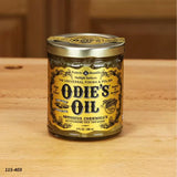 Odie's Oil universal wood finish and polish jar on a wooden surface