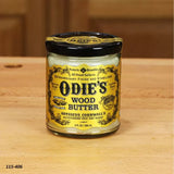 Odie's Wood Butter jar for woodworking finish and wood surface protection on wooden table.