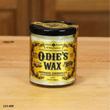 Odie's Wax jar for wood finishing on a wooden surface, woodworking tool accessory