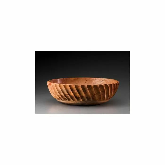 Handcrafted wooden bowl with spiral carved sides on dark background