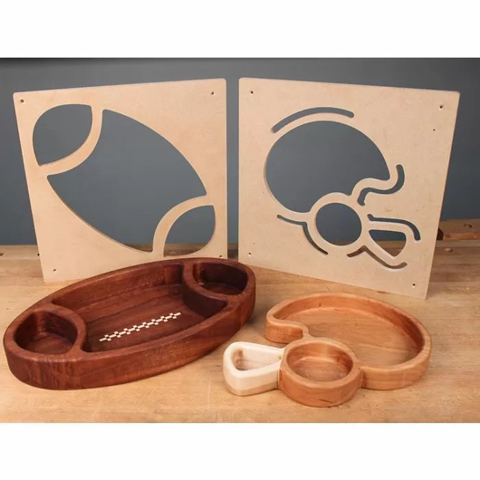 Wooden football and helmet-shaped serving trays with matching woodworking templates on workbench