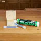 Two-part epoxy adhesive cartridge with mixing nozzles and wood joint on workbench