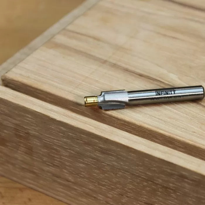 Woodworking router bit on wood surface, precision cutting tool for joinery projects
