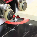 Woodworking router table setup with router bit cutting decorative edge on wood