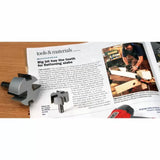 Woodworking planer bits on a magazine with article about flattening slabs, woodshop background