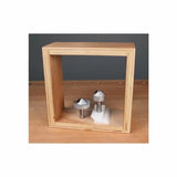 Chamfer router bits displayed on a wooden table in an open wooden box