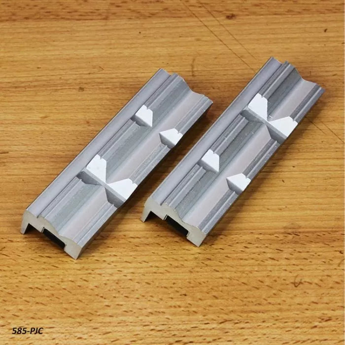 Aluminum dovetail track clamps on a wooden workbench for woodworking jigs and fixtures