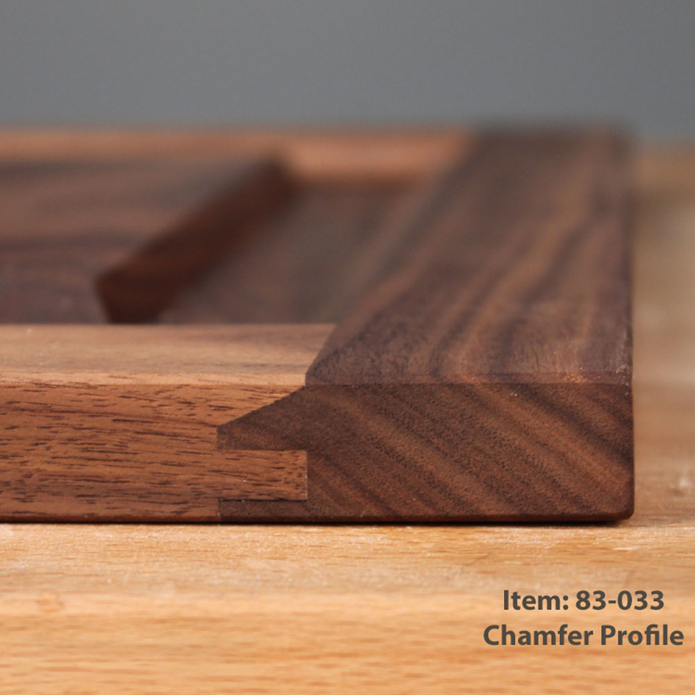 Close-up of a chamfered wooden profile joint showing the joint profile and wood grain, with text in the bottom right corner reading 'Item: 83-033 Chamfer Profile'.