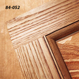 Close-up of wooden cabinet door corner showing detailed joinery and wood grain