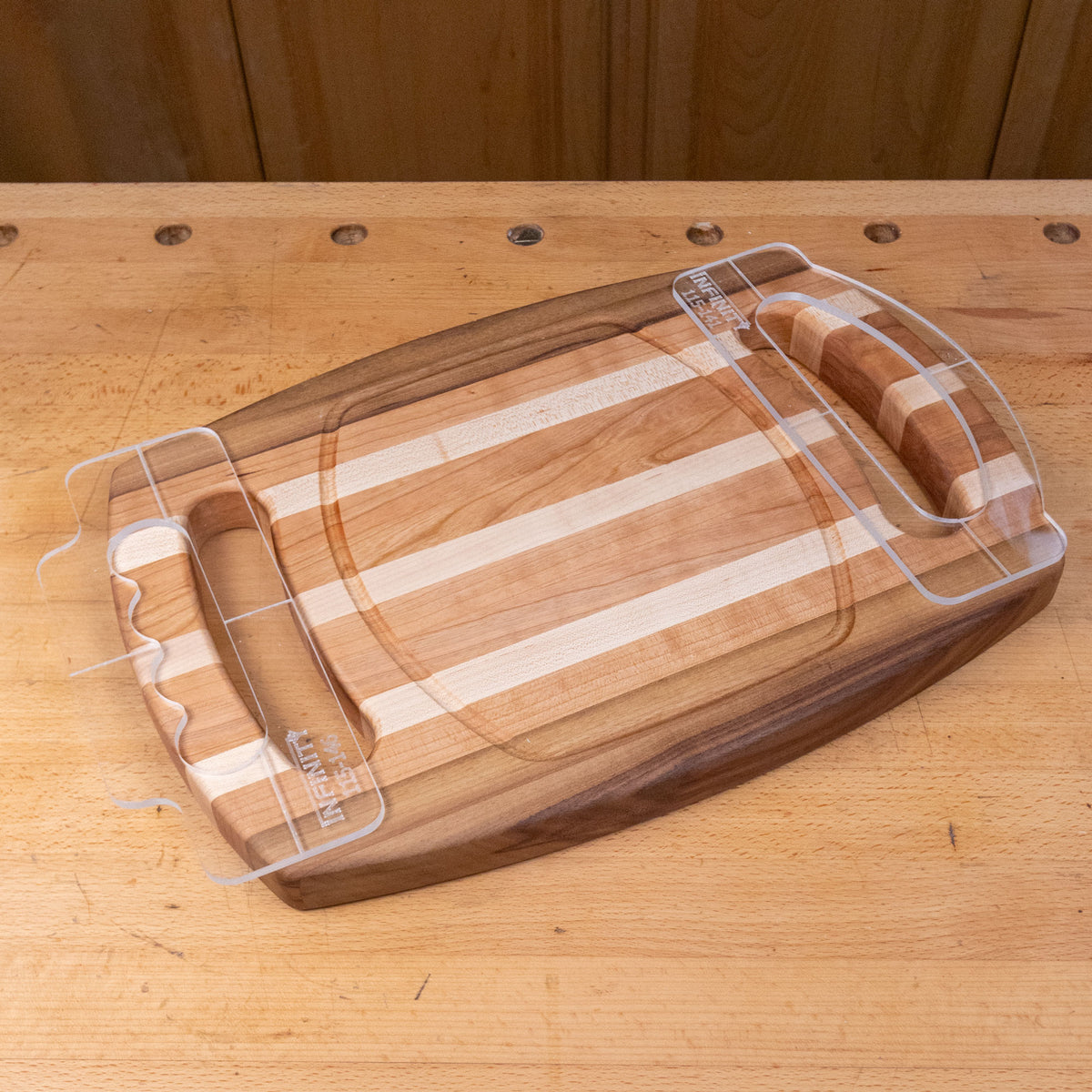 Wooden cutting board with finger groove handles on a workbench, woodworking tool accessory