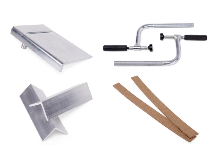 A set of various clamps, and vise jaws on a white background.
