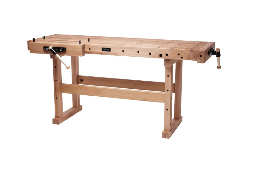 A light natural wood workbench with adjustable legs, a flat work surface, and a black-and-white clamp mechanism on the left side, shown on a plain white background.