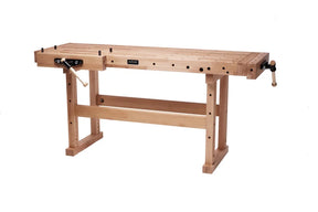 A light natural wood workbench with adjustable legs, a flat work surface, and a black-and-white clamp mechanism on the left side, shown on a plain white background.