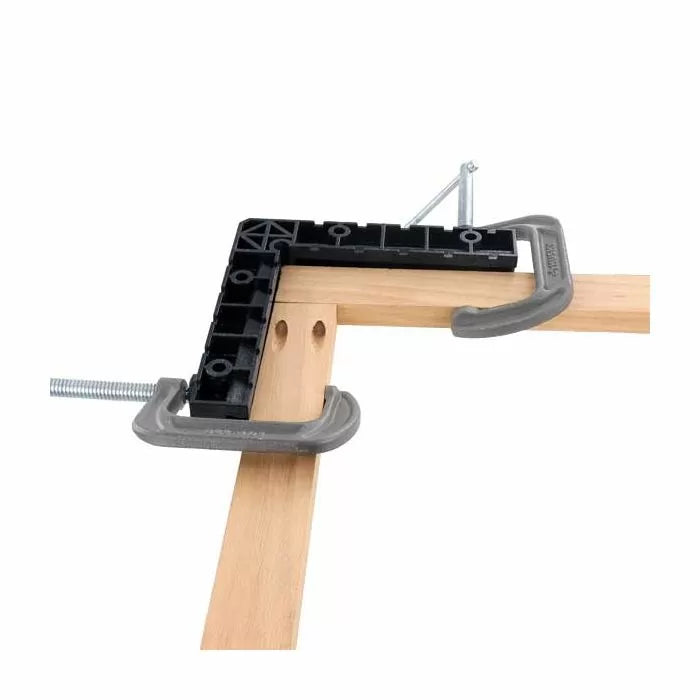 Woodworking corner clamp jig with C-clamps securing two wooden boards at a right angle