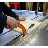 Using a table saw with a push block to cut wood for precise woodworking safety