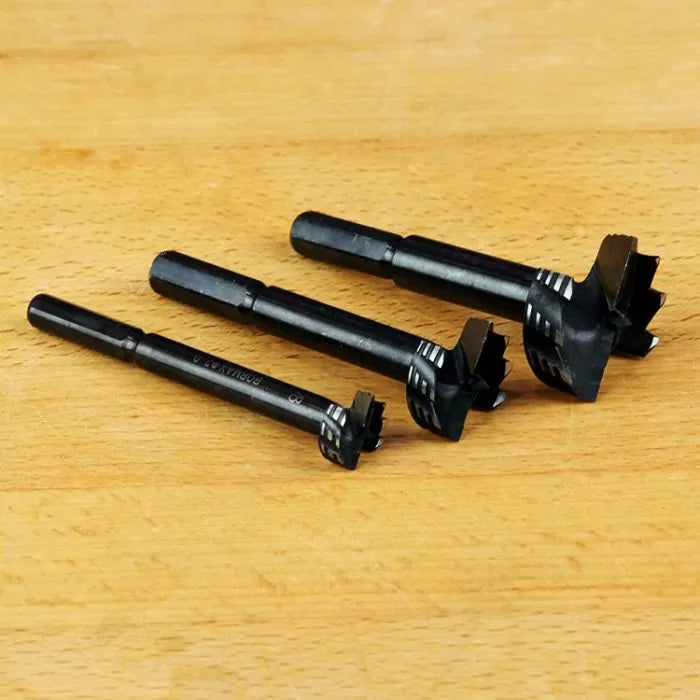 Set of three Forstner drill bits for woodworking on wooden surface