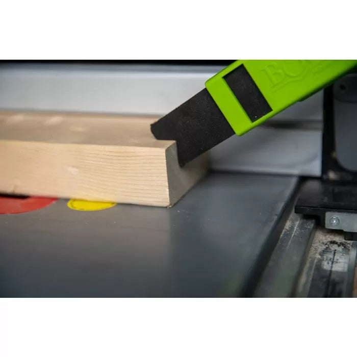 Table saw push stick guiding wood for precise and safe woodworking cut
