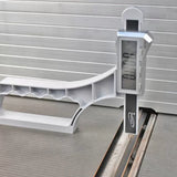 Digital caliper measuring table saw blade height on aluminum surface