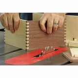 Woodworker assembling a dovetail joint box on a table saw with dado blade set