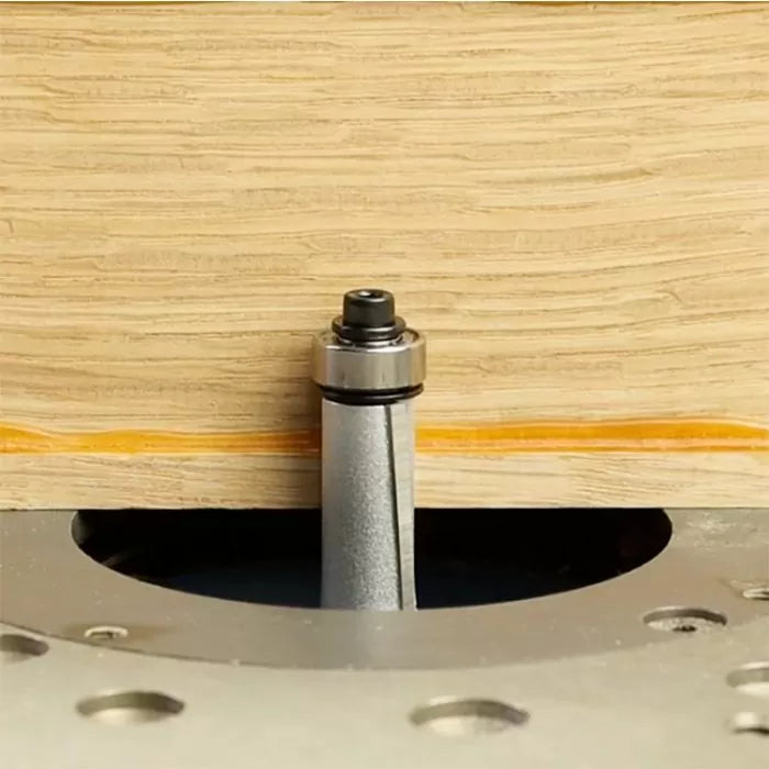 Flush trim router bit with bearing cutting wood edge on router table