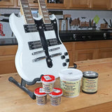 White double-neck electric guitar on workbench with wood grain fillers in woodworking shop