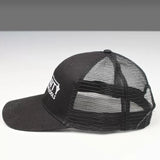 Black mesh trucker hat with white embroidered text, side view on plain background