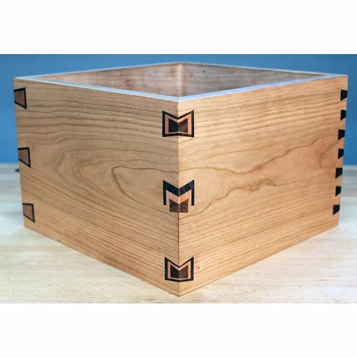 Wooden box with dovetail joints and decorative inlays, ideal for woodworking projects.