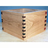Wooden box with decorative dovetail butterfly joints on a workbench, woodworking project