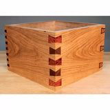 Handcrafted wooden box with decorative dovetail and bowtie joints, woodworking project