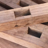 Close-up of mortise joints cut into hardwood, marked with pencil lines for precise woodworking.