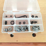 Woodworking router bit bearing and screw set in plastic organizer on wood table