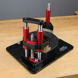 Precision router lift with red and black metal supports on a woodworking bench