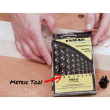 Hands holding FAMAG HSS-G metric drill bit set on a woodworking table