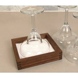 Stemmed wine glass upside down in a wood-framed salt rimmer on a kitchen counter