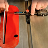 Digital caliper measuring distance between table saw blade and miter slot on metal surface