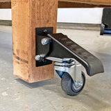 Workbench corner with installed locking caster wheel and foot lever on concrete floor