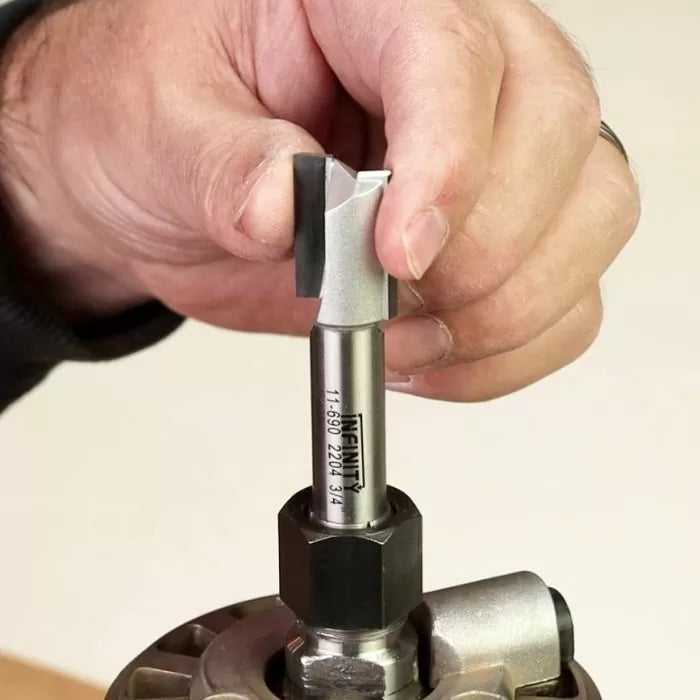 Hand installing a straight router bit into a woodworking router collet