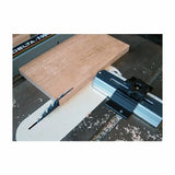 Table saw crosscut sled guide with wooden board on saw blade for precise woodworking cuts
