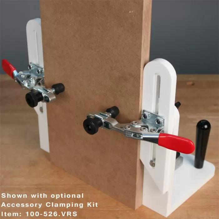 Woodworking clamping jig kit securing a wooden board for precise cutting or assembly